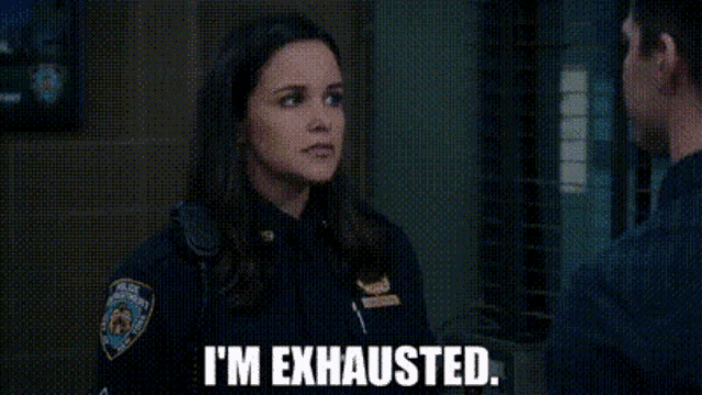 a woman in a police uniform is talking to a man and saying `` i 'm exhausted . ''