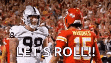a couple of football players standing next to each other on a field with the words `` let 's roll '' .