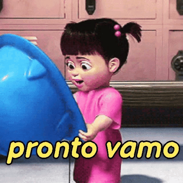 boo from monsters inc is holding a blue bowl and says pronto vamo in yellow letters