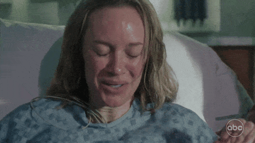 a woman in a hospital gown is smiling with abc written on the bottom right