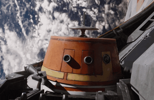 a close up of a robot 's face with a cloudy sky behind it