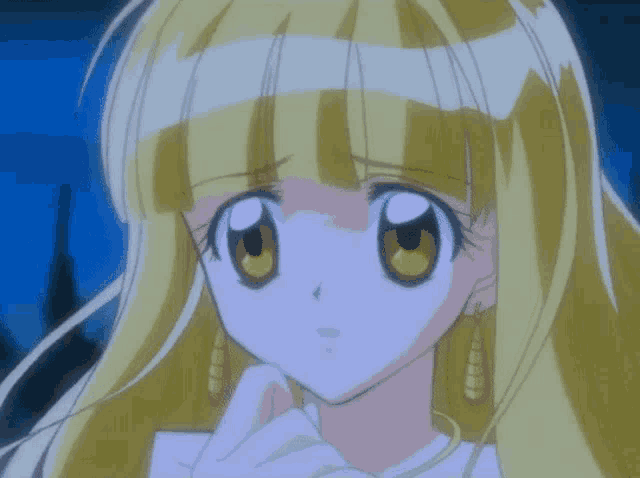 a close up of a girl 's face with blonde hair and yellow eyes