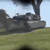 a tank is driving down a grassy hill in a field .