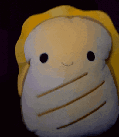 a stuffed animal that looks like a piece of bread with a smile on its face