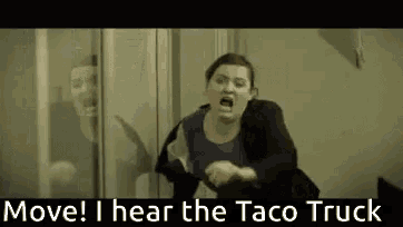 a woman is screaming in a room with the words move i hear the taco truck
