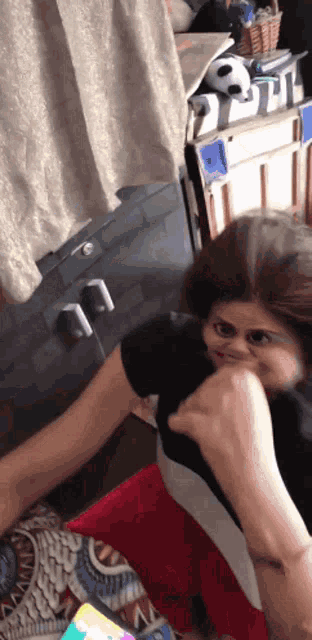 a woman is making a funny face while being punched in the face