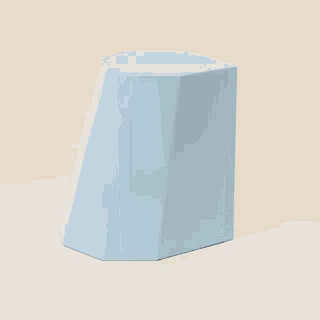 a light blue hexagon shaped object is sitting on a table