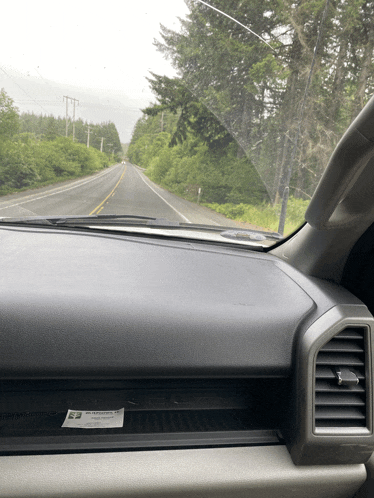 a dashboard of a car with a sticker on it that says ' warning ' on it