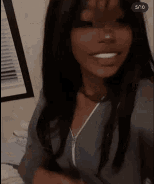 a woman is taking a selfie in front of a window in a room .
