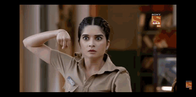 a woman in a police uniform is making a funny face in front of a sony sab logo