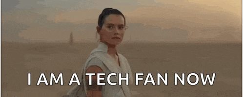 a woman is standing in the desert with the words `` i am a tech fan now '' written below her .