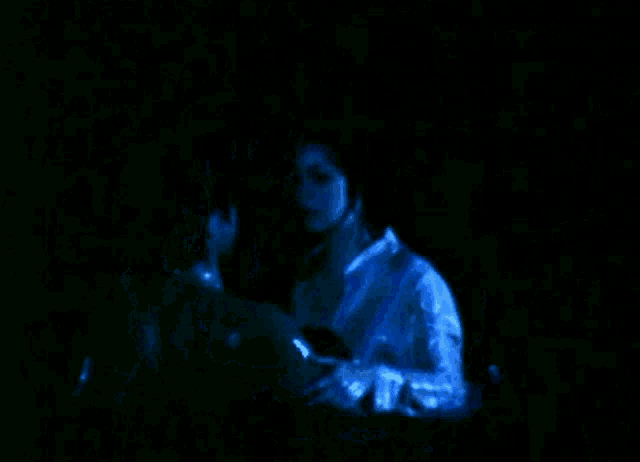 a man and a woman are hugging in the dark