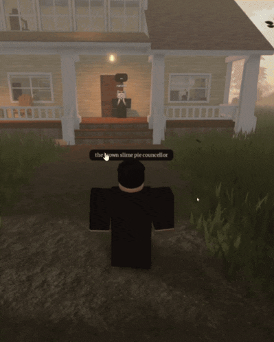 a screenshot of a video game shows a man standing in front of a door that says the who on it