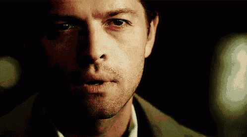 a close up of a man 's face in the dark