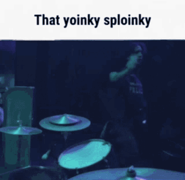 a person playing drums in a dark room with the words that yoinky sploinky