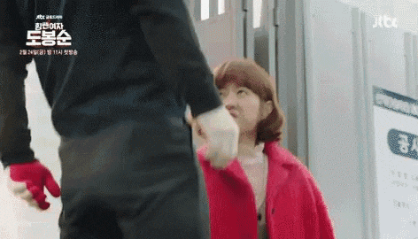 a man and a woman are standing next to each other .