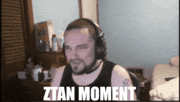 a man wearing headphones with the words ztan moment on the screen