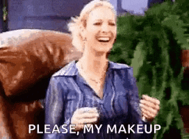 a woman is sitting in a chair holding a glass of wine and laughing while saying `` please , my makeup '' .