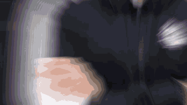 a blurry picture of a person 's arm with a purple stripe on it