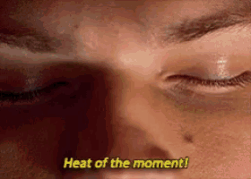 a close up of a person 's face with the words heat of the moment written above it