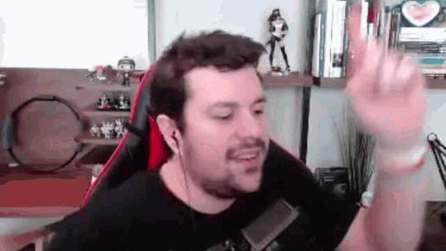 a man is sitting in a chair in front of a microphone in a room .