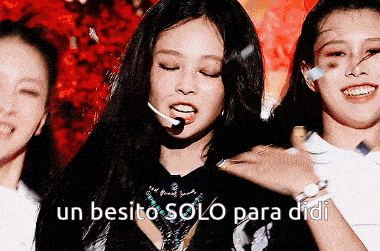a girl with a microphone in her mouth is surrounded by other girls and says un besito solo para didi