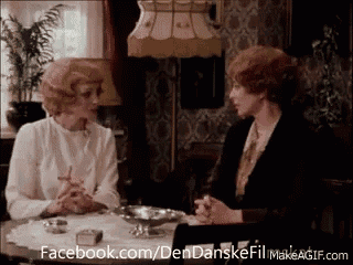 two women are sitting at a table talking to each other with facebook.com/dendanskefil makeagif.com in the corner