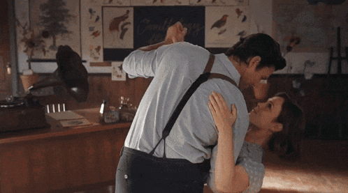 a man and a woman are dancing in front of a sign that says " cranberry "