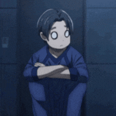 a young boy is sitting with his arms crossed and making a funny face