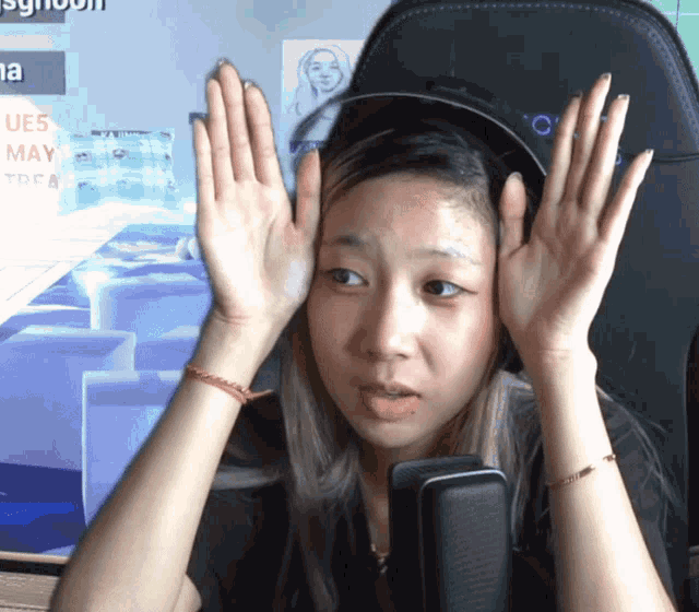 a woman sitting in front of a screen that says ue5 may