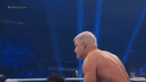 two men are fighting in a wrestling ring with a referee watching .