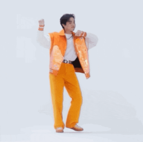 a man in an orange jacket and yellow pants is dancing .
