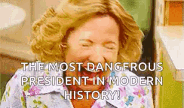 a woman is laughing with her eyes closed and says `` the most dangerous president in modern history '' .