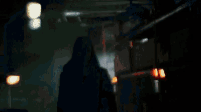 a shadow of a person is cast on a red and orange background
