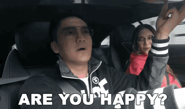 a man and a woman in a car with the words are you happy
