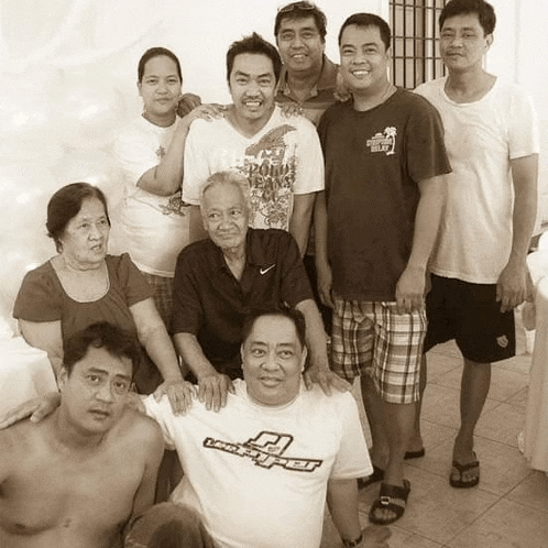 a group of people posing for a picture with one man wearing a t-shirt that says landspeeder