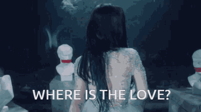 a woman in a white dress is standing in front of statues and the words where is the love