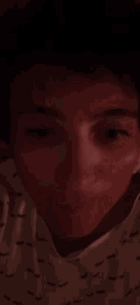 a close up of a person 's face in the dark