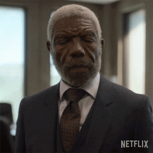 a man in a suit and tie with a netflix logo on the bottom