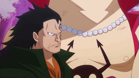 a man with a beard is standing next to another man with a necklace on his neck