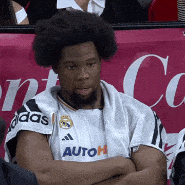 a man wearing a white adidas shirt with autoh written on the front