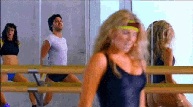 a group of people are dancing in a gym .
