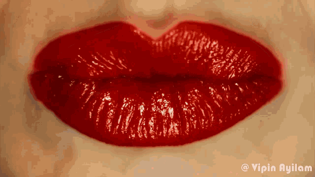 a close up of a woman 's red lips with a caption that says vipin ayilam