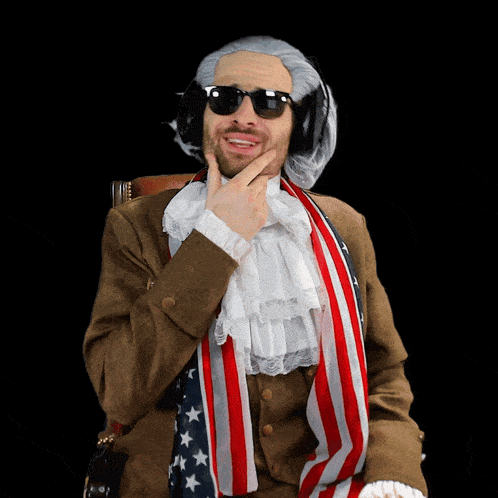 a man in a wig and sunglasses is wearing an american flag scarf around his neck