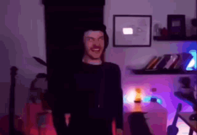 a blurry picture of a man standing in a room with purple lights .