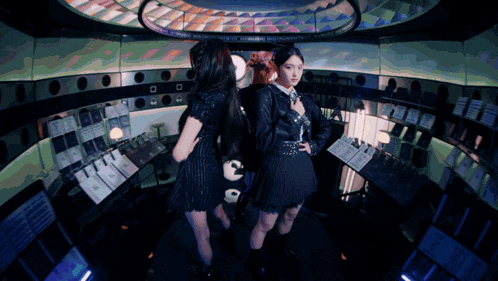 three women are standing in a dark room with a sign that says ' emergency exit ' on it