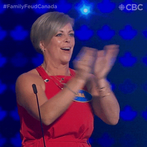 a woman in a red dress with a name tag that says ana is clapping