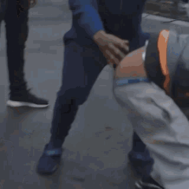 a blurry picture of a man fighting another man in a park .