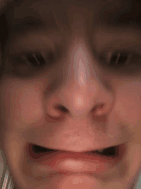 a close up of a person 's face with a mouth open