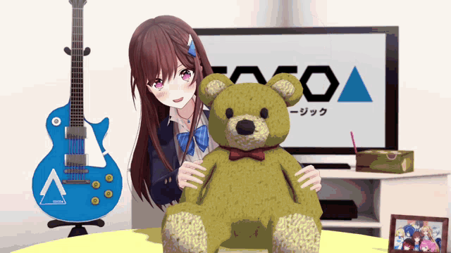 a girl holding a teddy bear in front of a tv and a blue guitar with the letter a on it